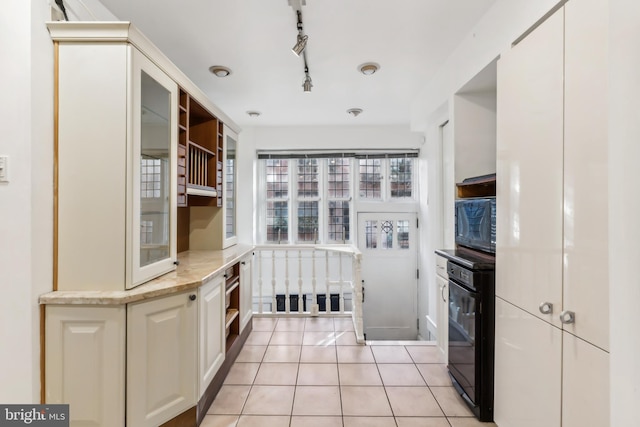 kitchen featuring light tile patterned flooring, rail lighting, and black microwave