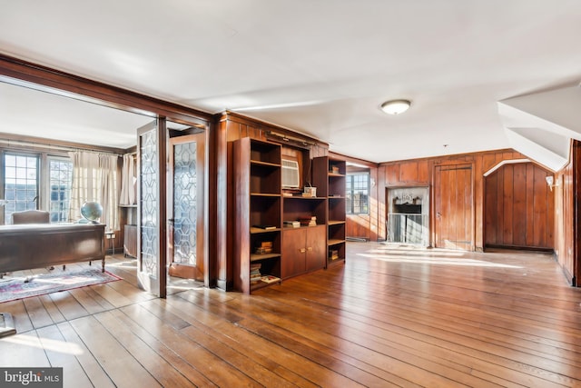 living room with wood-type flooring and wooden walls