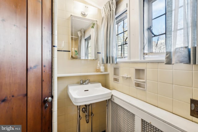 bathroom with tile walls and tasteful backsplash