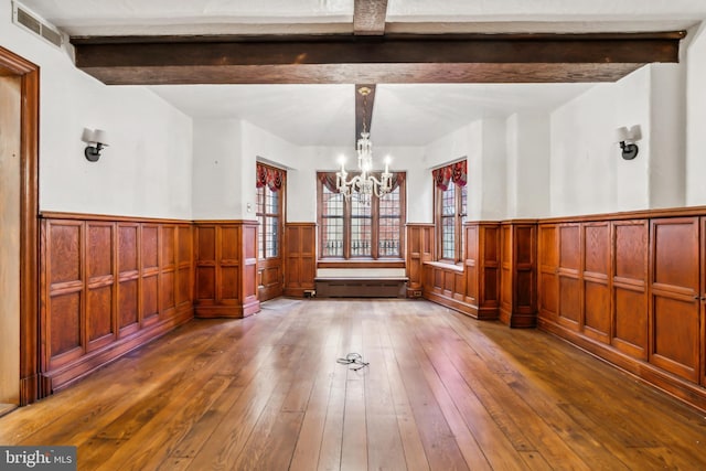 interior space featuring beam ceiling, a chandelier, and dark wood-type flooring