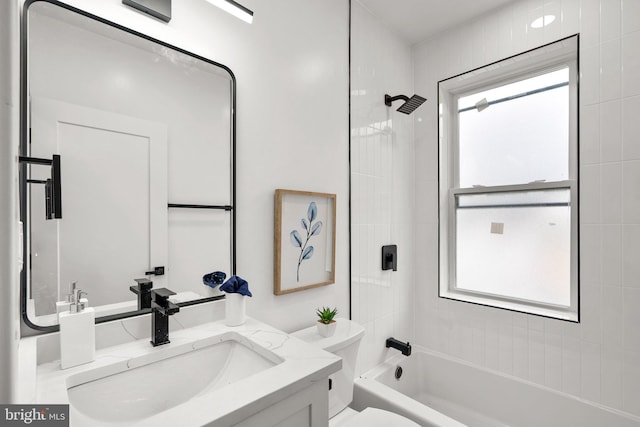 full bathroom with vanity, toilet, and tiled shower / bath