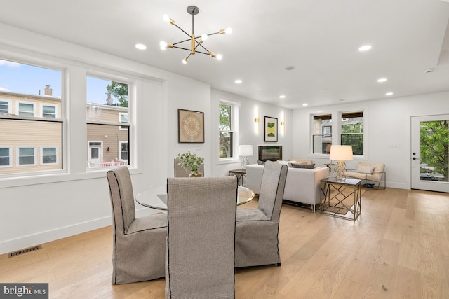 dining room featuring a chandelier and light hardwood / wood-style floors