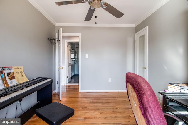 office space featuring light wood-type flooring, ceiling fan, and ornamental molding