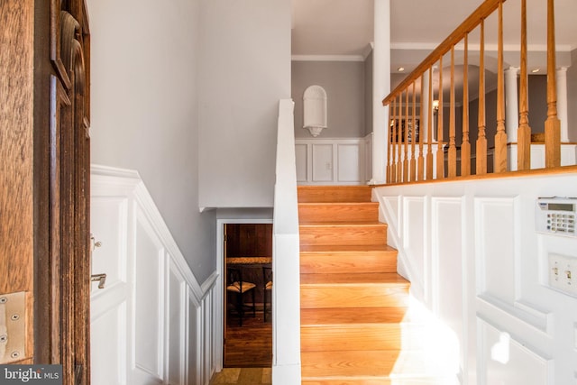 staircase featuring crown molding