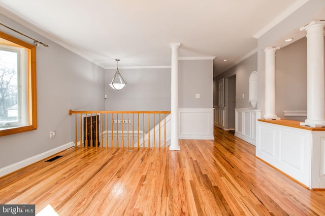 spare room with light hardwood / wood-style floors and ornamental molding