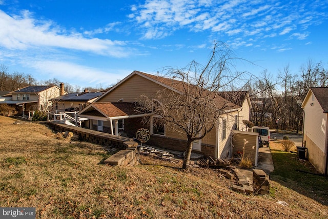 back of property featuring a yard