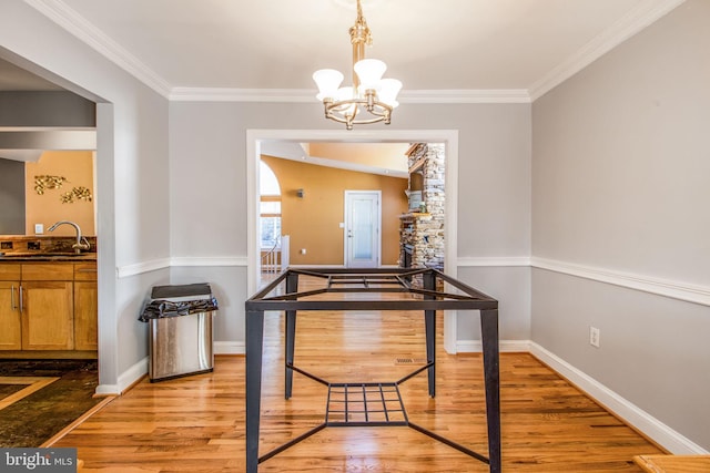 dining area with light hardwood / wood-style floors and crown molding