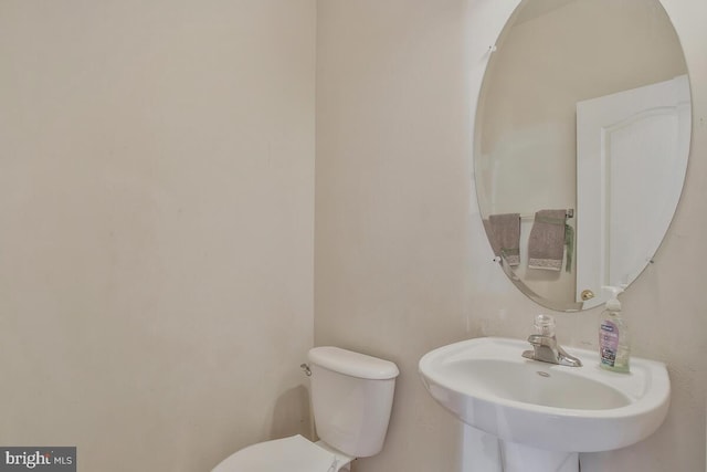 bathroom featuring sink and toilet