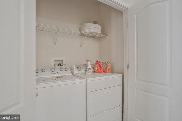 clothes washing area with washing machine and clothes dryer