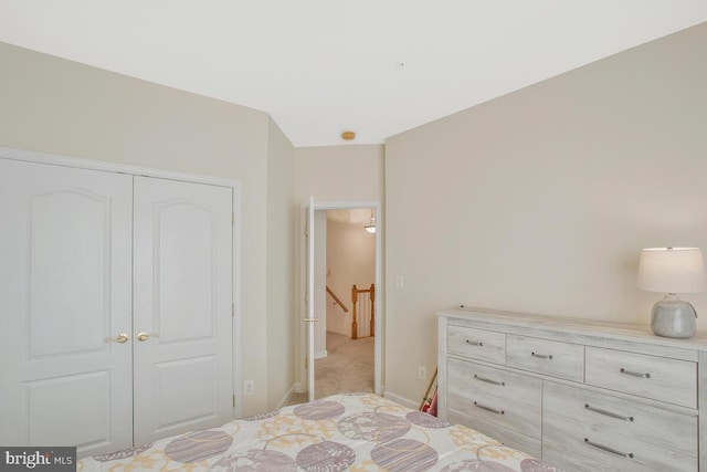 bedroom featuring light carpet and a closet