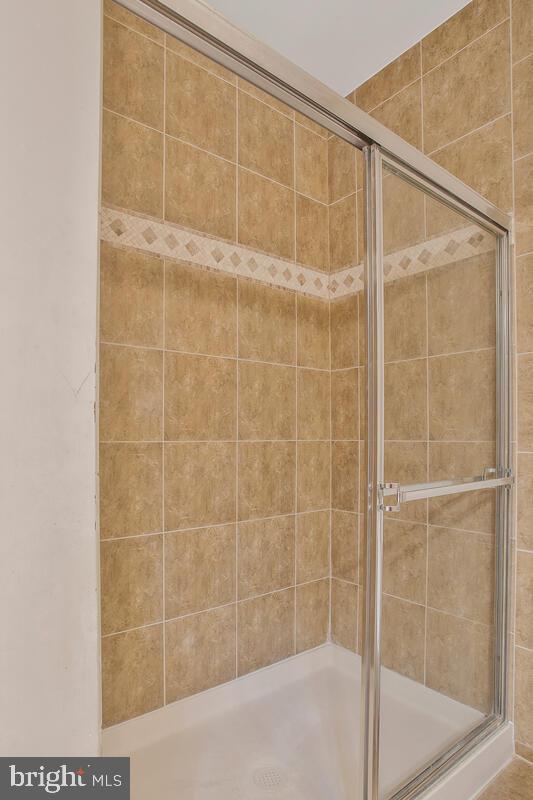 bathroom featuring a shower with door