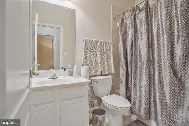 bathroom featuring toilet, vanity, and a shower with shower curtain