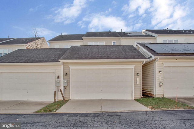 view of front of home featuring a garage and solar panels