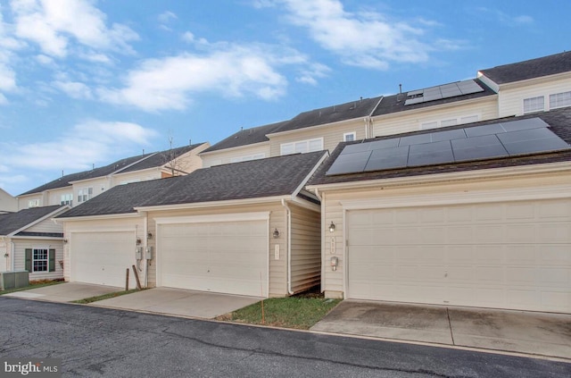 view of property with a garage and solar panels