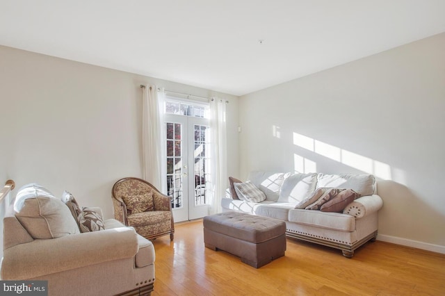 living room featuring french doors and light wood-type flooring