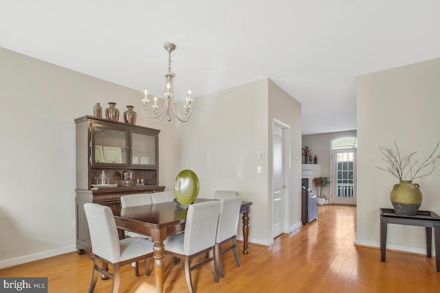 dining space featuring a chandelier and light wood-type flooring