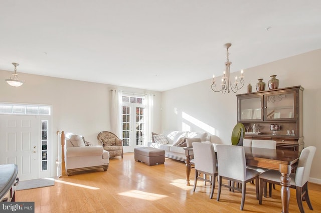 dining room with a chandelier and light hardwood / wood-style floors