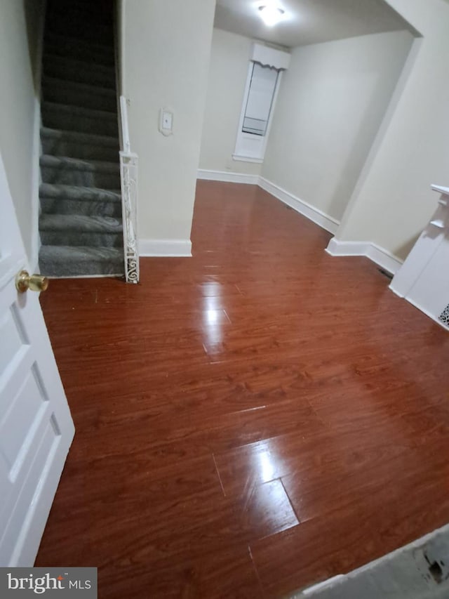 spare room with dark wood-type flooring