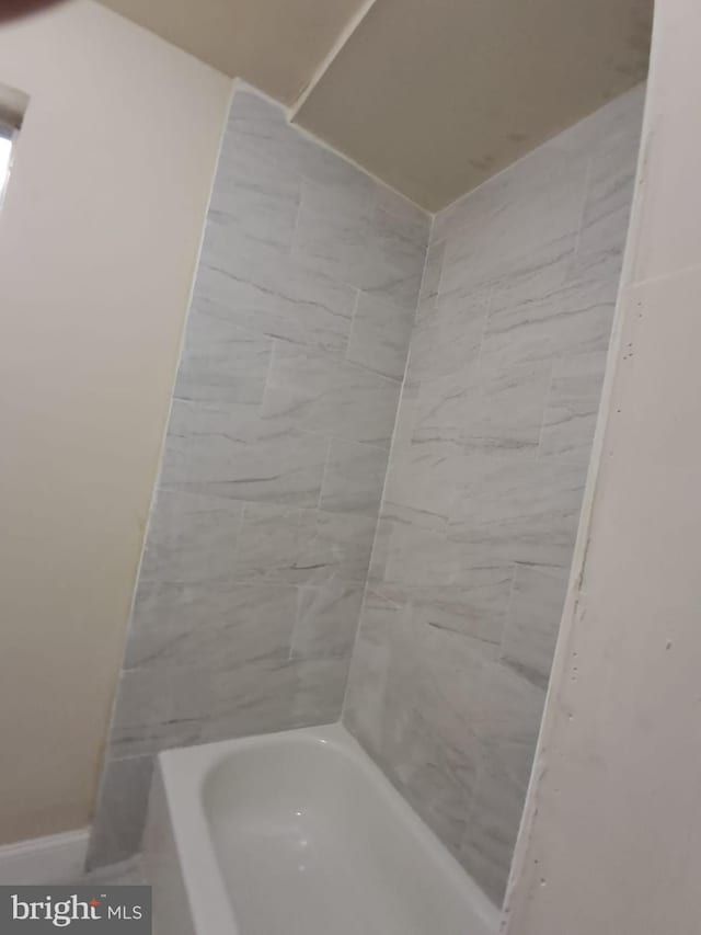 bathroom featuring a tub to relax in