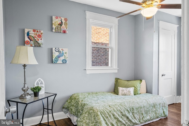 bedroom featuring ceiling fan and dark wood-type flooring