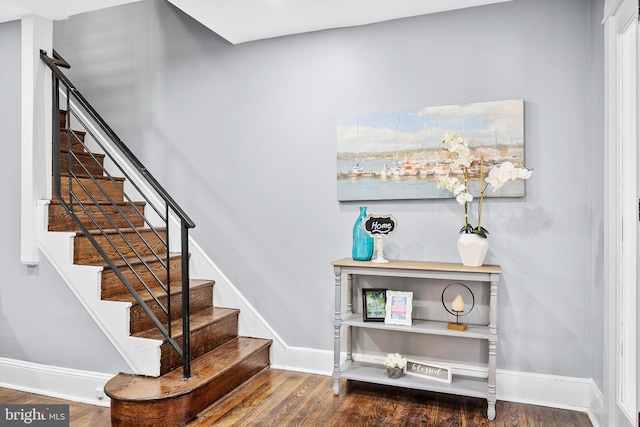 stairs featuring hardwood / wood-style flooring