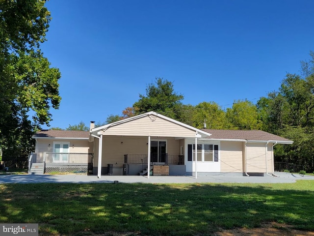 rear view of property with a yard