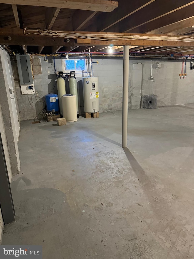 basement with electric panel and electric water heater