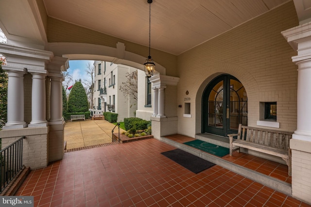 view of patio / terrace featuring a porch and french doors