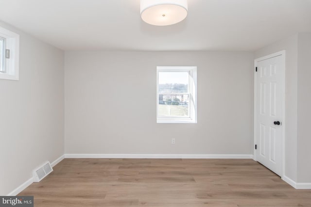 spare room with light hardwood / wood-style flooring