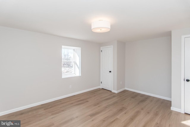 empty room with light hardwood / wood-style floors