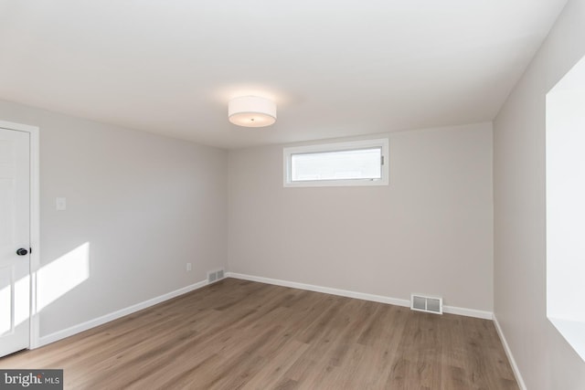 spare room featuring wood-type flooring