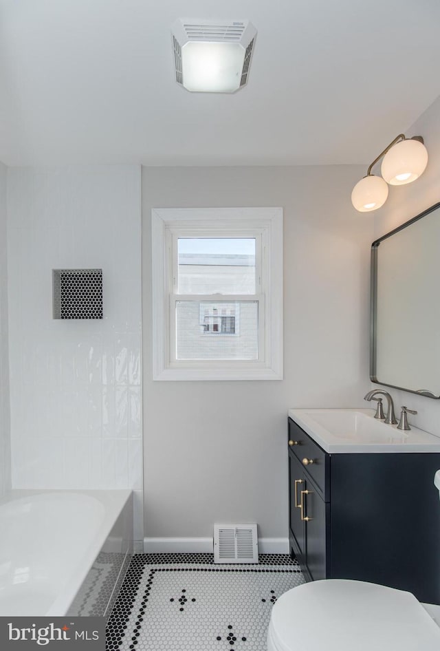 bathroom with tile patterned flooring, vanity, and toilet