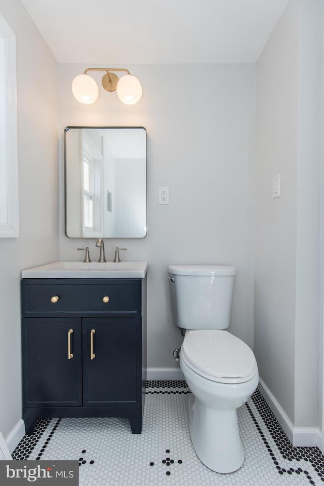 bathroom featuring tile patterned flooring, vanity, and toilet