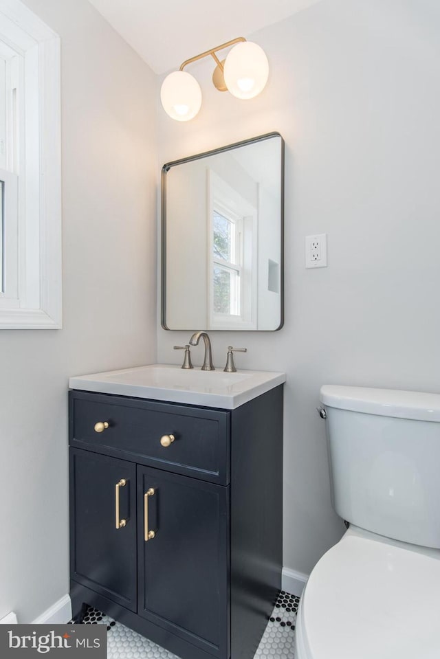 bathroom featuring tile patterned floors, vanity, and toilet