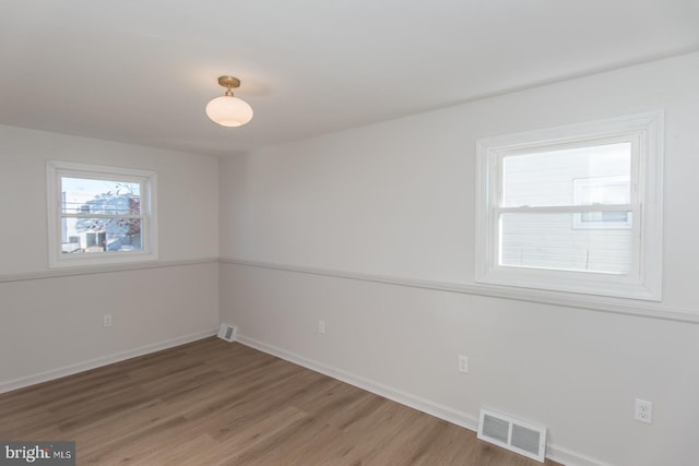 unfurnished room featuring hardwood / wood-style flooring