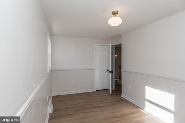 empty room with wood-type flooring