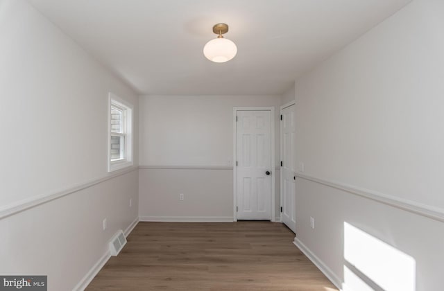 spare room featuring wood-type flooring