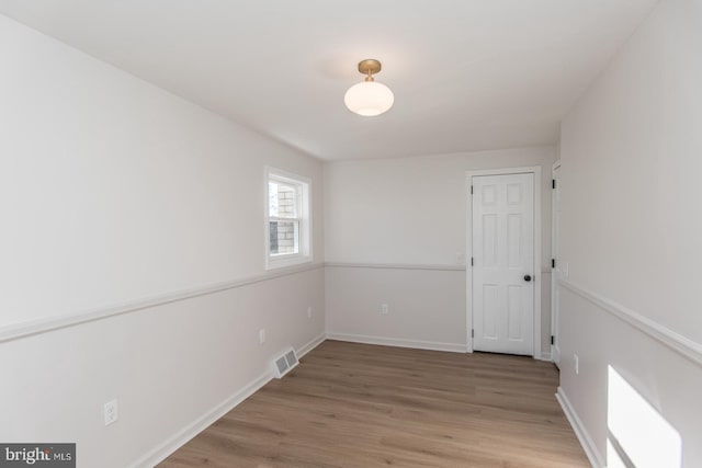 spare room featuring wood-type flooring