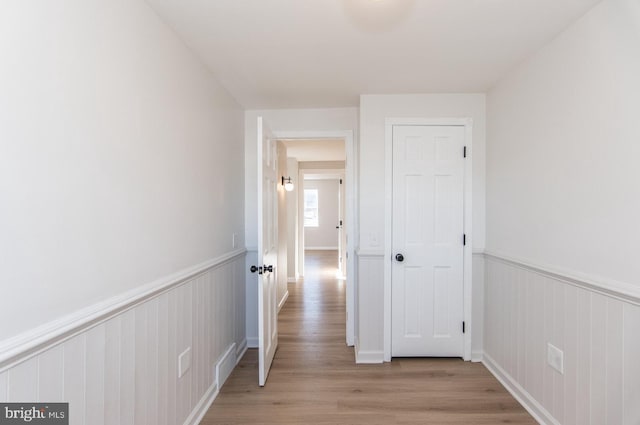 corridor with light hardwood / wood-style floors