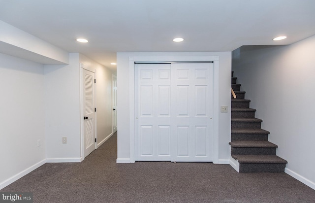 basement featuring dark carpet