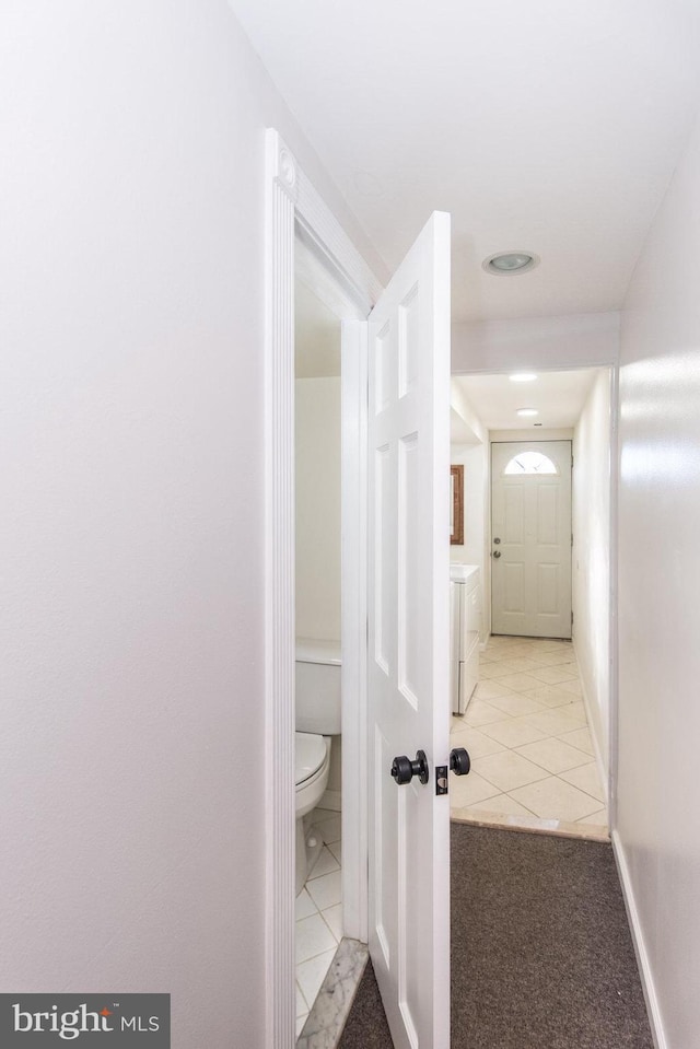 corridor featuring light tile patterned floors