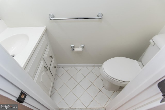 bathroom featuring tile patterned floors, vanity, and toilet