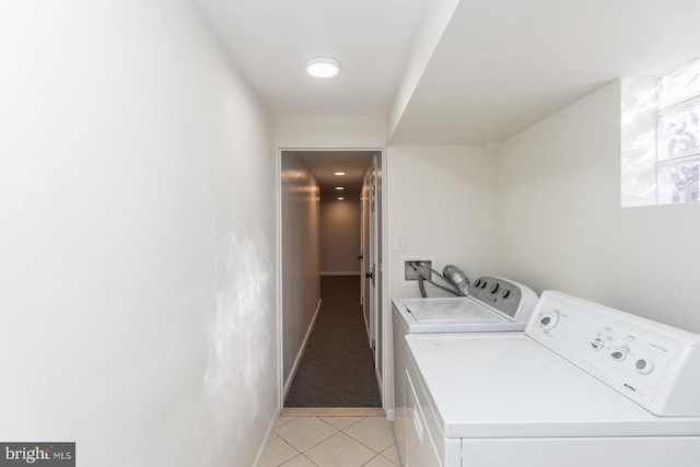 clothes washing area with separate washer and dryer and light tile patterned floors