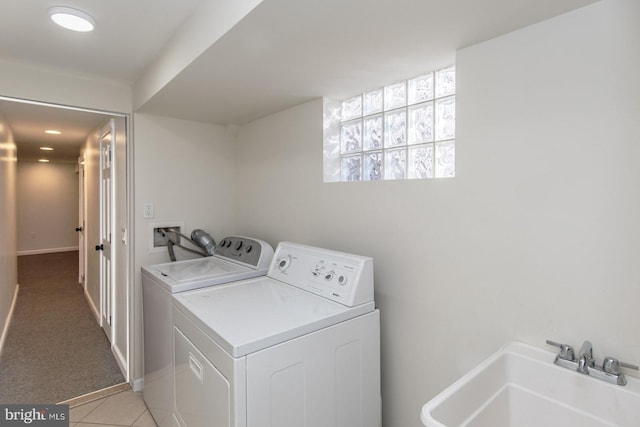 laundry area with separate washer and dryer, light colored carpet, and sink