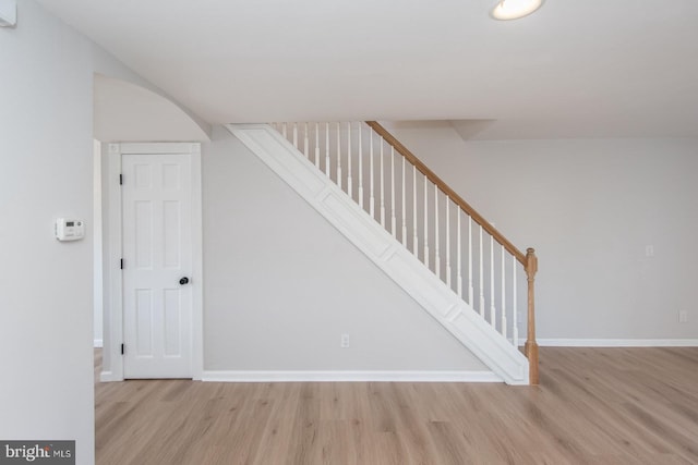 staircase with hardwood / wood-style flooring