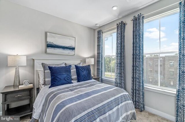 bedroom with light colored carpet