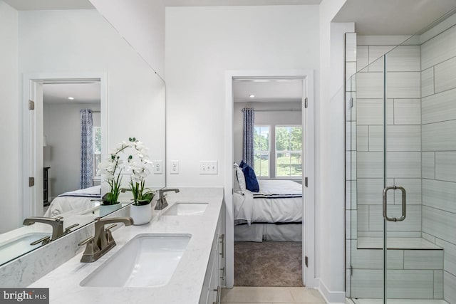 bathroom with tile patterned flooring, vanity, and walk in shower