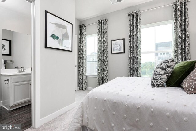 carpeted bedroom with multiple windows