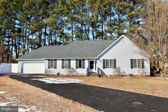 ranch-style house featuring a garage and a front yard