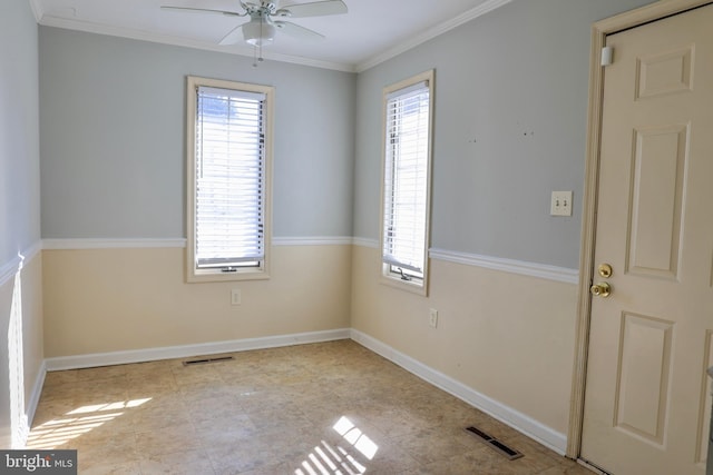 unfurnished room with ceiling fan, a wealth of natural light, and crown molding